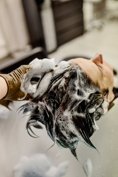 Woman in hair salon getting hair washed