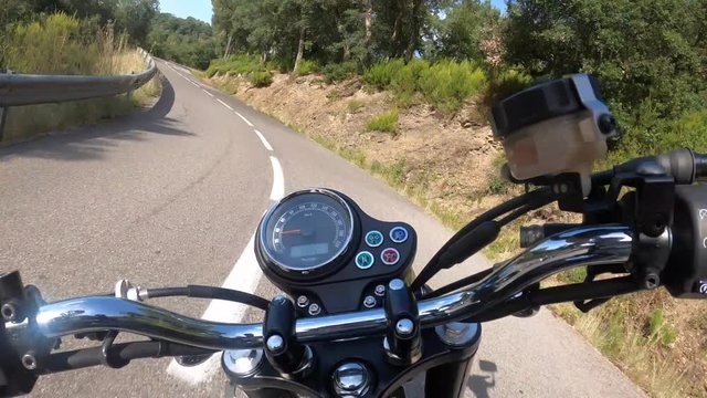Riding an old black motorbike on a curly asphalt tarmac road driver point of view time lapse