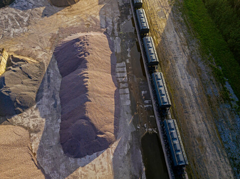 Russia, Tikhvin, Aerial view of railroad cars along sand pit in asphalt plant