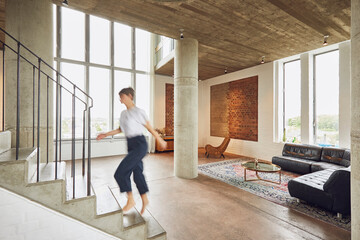 Woman walking up stairs in a loft flat