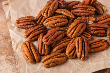 Pecans on paper, brown background,, full size