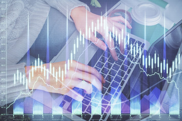 Plakat Double exposure of woman hands typing on computer and forex chart hologram drawing. Stock market invest concept.
