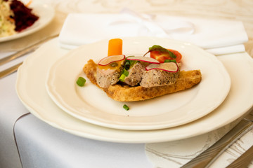 A healthy dish with meat and vegetables. Healthy food in a restaurant. Table setting with white plates