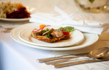 A healthy dish with meat and vegetables. Healthy food in a restaurant. Table setting with white plates. First course