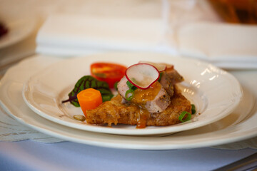 A healthy dish with meat and vegetables. Healthy food in a restaurant. Table setting with white plates
