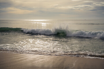 Beautiful waves and clouds over the sea at sunset. warm pastels tones 