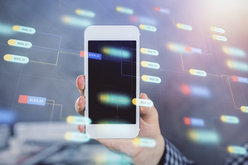 Double exposure of man's hand holding and using a digital device and data theme hologram drawing. Technology concept.