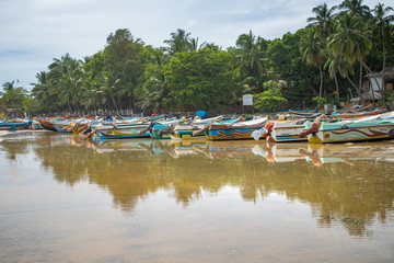 Fototapeta na wymiar colorful fishing boats on the beach, Arugam Bay, Sri Lanka
