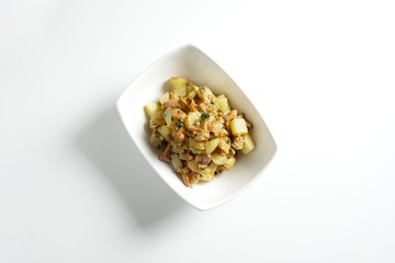 Baked potato with fried chanterelle mushrooms on a white plate