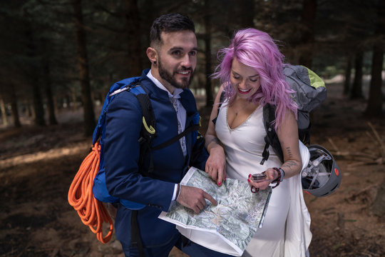 Bridal couple with hiking map in the woods