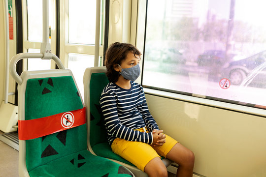 Boy wearing protective mask in tramway