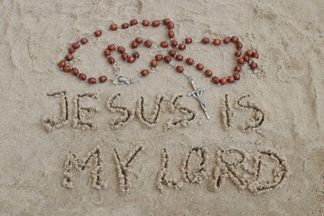 a rosary lying on the sand