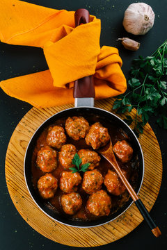 Pan with hot homemade meatball stew made with minced meat seasoned with various spices for flavor.