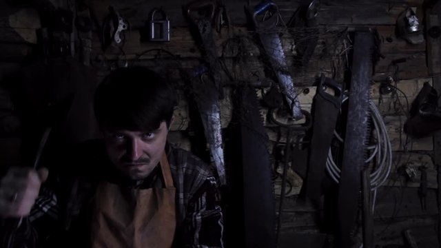 Angry crazy maniac with a rusty ax in an old house. copy space