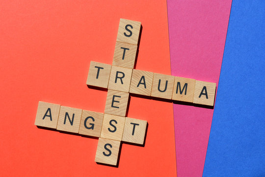 Stress, Trauma, Angst, words in wooden alphabet letters in crossword form on colourful background.