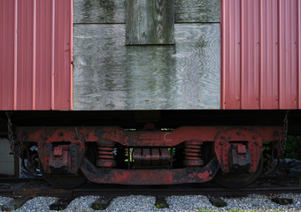 Retired and rusting and rotting old rail road box cars on abandoned track