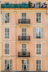Fototapeta premium French old house with original design of balconies and windows. Nice, Cote d'Azur, France.