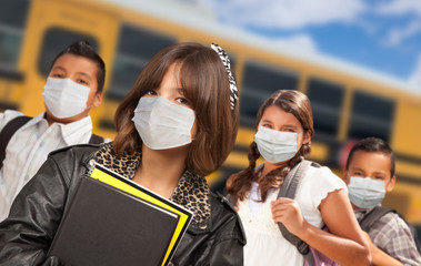 Hispanic Students Near School Bus Wearing Medical Face Face Masks