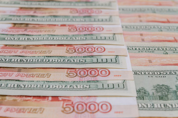 A large number of American hundred dollar bills and Russian five thousand dollar bills