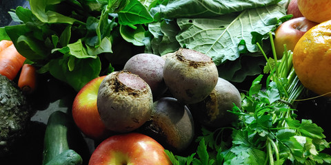 A small variety of fruits and vegetables that have just arrived from the organic fair.