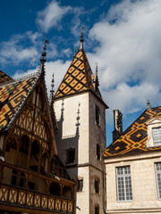 Fototapeta na wymiar Beautiful ancient architecture of Burgundy. Streets of the city of Beaune. Sunny spring day. Advertising tourist types.