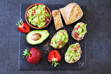 Guacamole toast with strawberries. Healthy snack. Strawberry guacamole.