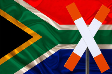 customs sign, stop, attention on the background of the silk national flag of the country of South Africa, the concept of border and customs control, violation of the state border, tourism restrictions