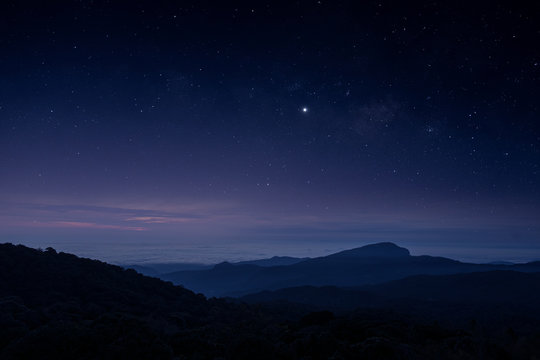Stars and Milky Way in the dark night sky on the mountains of northern Thailand.