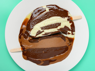 top view melted popsicles one is chocolate flavor the other one is vanilla flavor