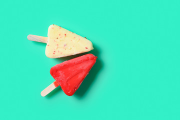 top view fresh two different colors chocolate outer popsicles on light green color