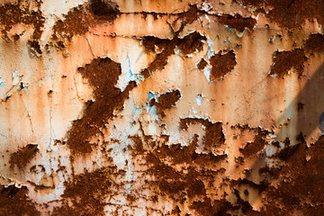 The texture of cracked paint on a rusty metal surface.