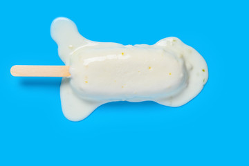 top view mango and condensed milk flavor popsicle melting on blue background