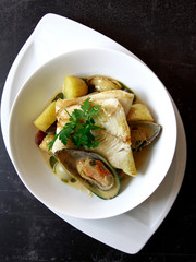 Hake with mussels and potatoes in a mild curry veloute