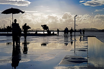Silhouette of people walking after rain, Rio