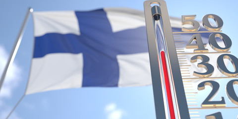 Thermometer shows high air temperature against blurred flag of Finland. Hot weather forecast related 3D rendering