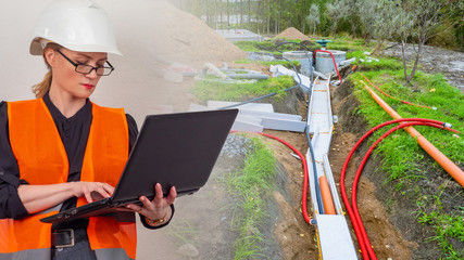 Water pipe laying. Woman engineer is working on water pipe. Construction worker next to pipes. Architect holds laptop. Design of sewer networks. Pipe laying during house construction. Woman architect