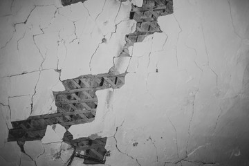 Dilapidated ceiling of an old house. damaged wall with a hole with timber frame. ruined surface abstract background
