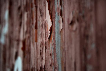 Old deteriorating wall with peeling red paint