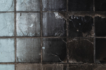 Burnt tiled wall in an old abandoned building. grunge background