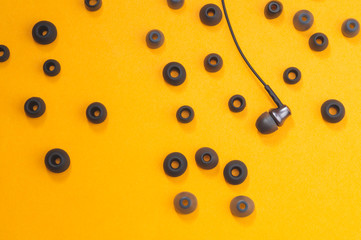 Earphones between of ear cushions. in-ear headphones with many embouchures. audio equipment