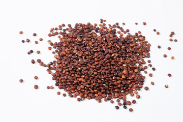 Pile of healthy south american grain red Quinoa on white background.