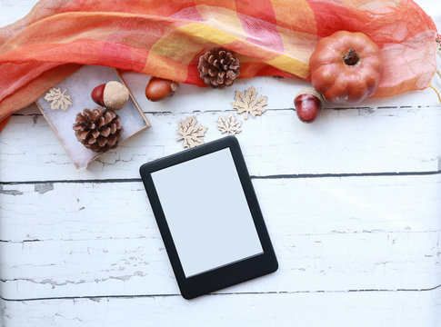 Top View Of An Empty Ebook On A Rustic White Wood Surface Surrounded By Fall-themed Items
Autumn Themed Ereader Flat Lay With Copy Space            