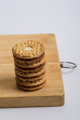 Fototapeta na wymiar Cream sandwich biscuits on the wooden board 