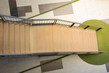 Top view shot of beautiful stairway down from high level to the ground of modern style building with nobody shows the concept of way to success in life or business. It is empty space for frame