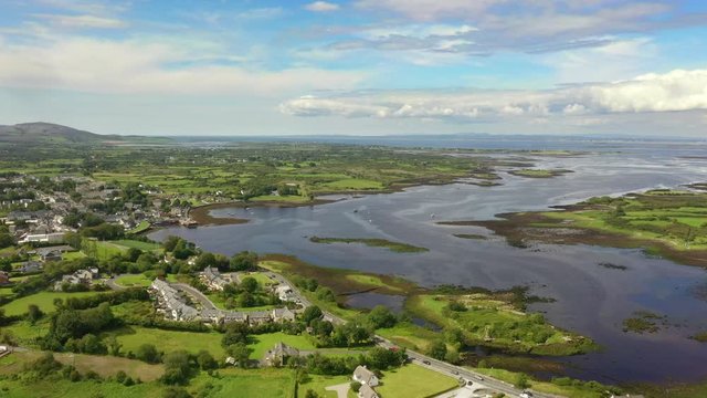 Kinvara, Galway, Ireland, August 2020, Drone flying high while slowly tracking parallel to fishing village.