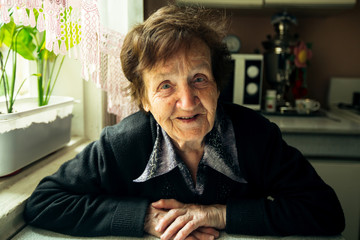 Fototapeta premium Portrait of a smiling old woman in her house.
