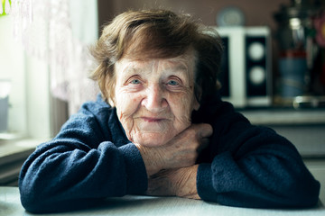 Close-up portrait of an Old woman in her home. - 370881989