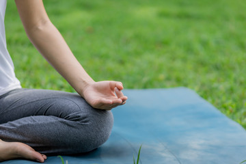 Healthy women doing yoga in the moring at the park . concept healthy and outdoor activity.