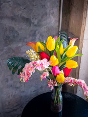  fresh spring flowers on brick wall background