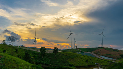 Wind turbine in sunset sky, renewable energy for sustainable ecology